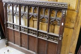 A carved oak tracery panel