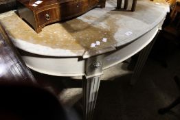 A white painted marble top console table