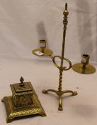 A brass candlestick and inkwell