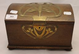 An Art Nouveau brass mounted oak casket