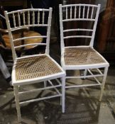 A pair of white painted faux bamboo chairs