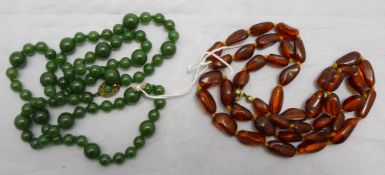 A string of amber beads and a string of jade beads