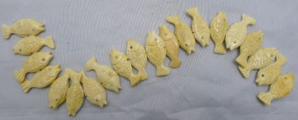 A string of carved bone fish