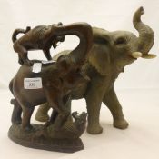 A carved wooden elephant group and another