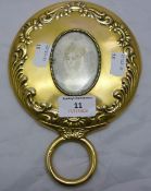 A silver gilt hand mirror with inset miniature