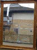 A large gilt framed mirror