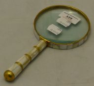 A mother-of-pearl magnifying glass