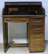 An early 20th century oak tambour front desk