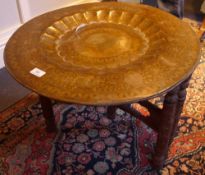 An Indian brass topped folding table