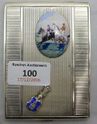 A silver cigarette case depicting horse racing