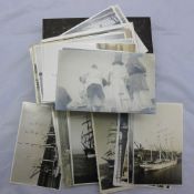 A quantity of shipping related postcards and photographs