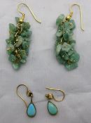 A pair of turquoise earrings and another pair