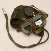 A flying helmet and goggles