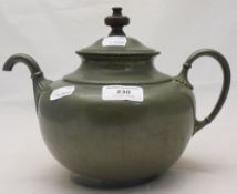 A pewter self-pour teapot,