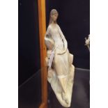 A Nao figurine of a lady carrying water urn  No chips, cracks or restoration in good condition