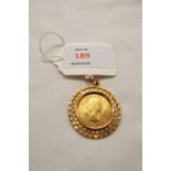 A 1963 gold sovereign housed in a circular gold mount  Weighs approx 8 grams