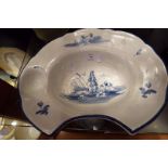 An oval shaped Delft barbers bowl hand-painted with a shepherdess with sheep beside a river   No