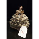 A Dresden figurine of a crinoline laced lady