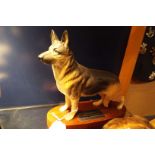 A Beswick Alsatian dog on wooden stand