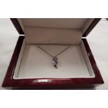 A 9ct white gold tanzanite pendant and chain,