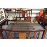 An Edwardian mahogany double bed the slatted head and foot-boards chequer strung with inlaid star