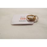 An 18ct gold ring set with five diamonds,