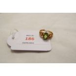 A 9ct gold ring set with peridot and clear stones,