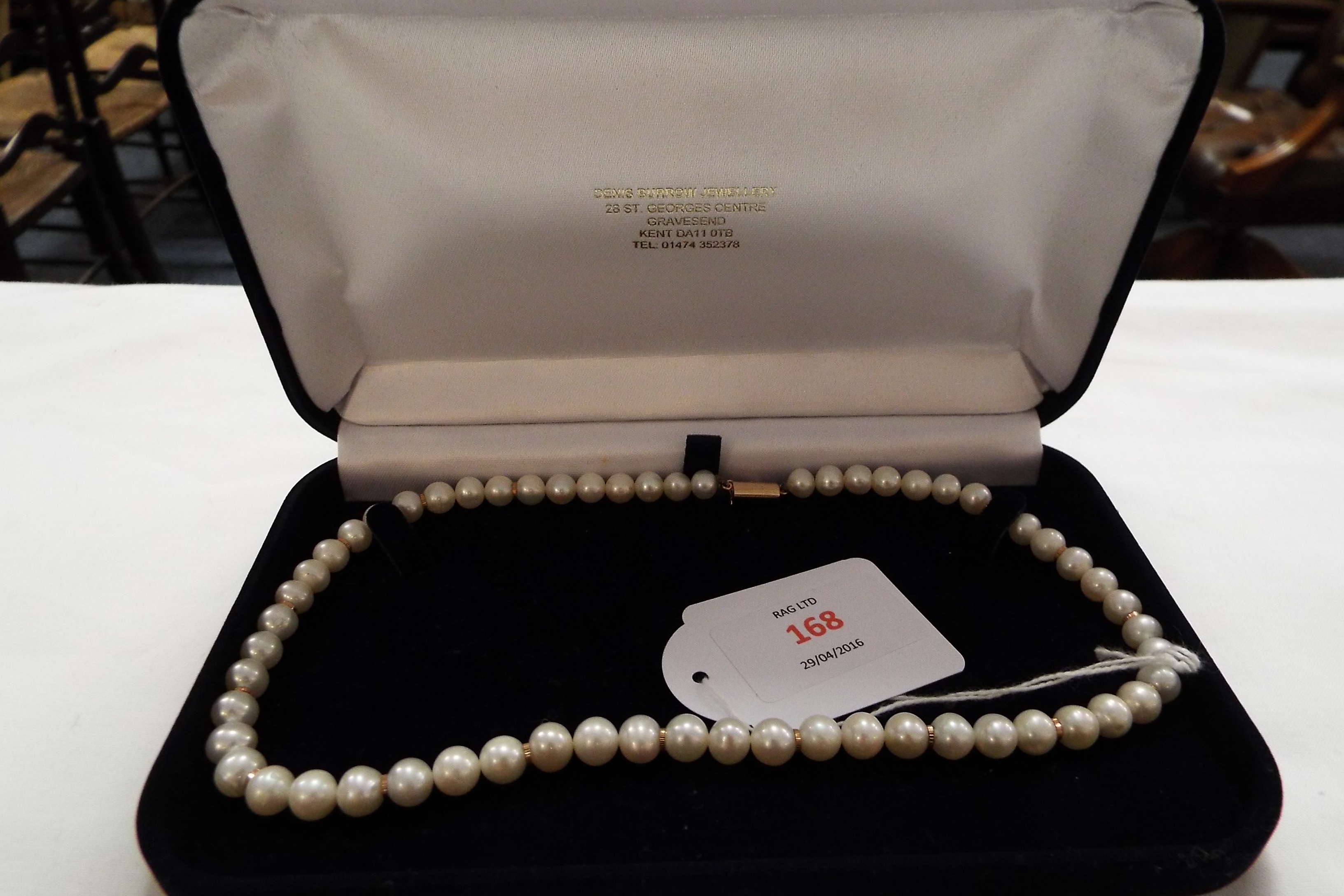 A string of cultured pearls with unmarked gold clasp,