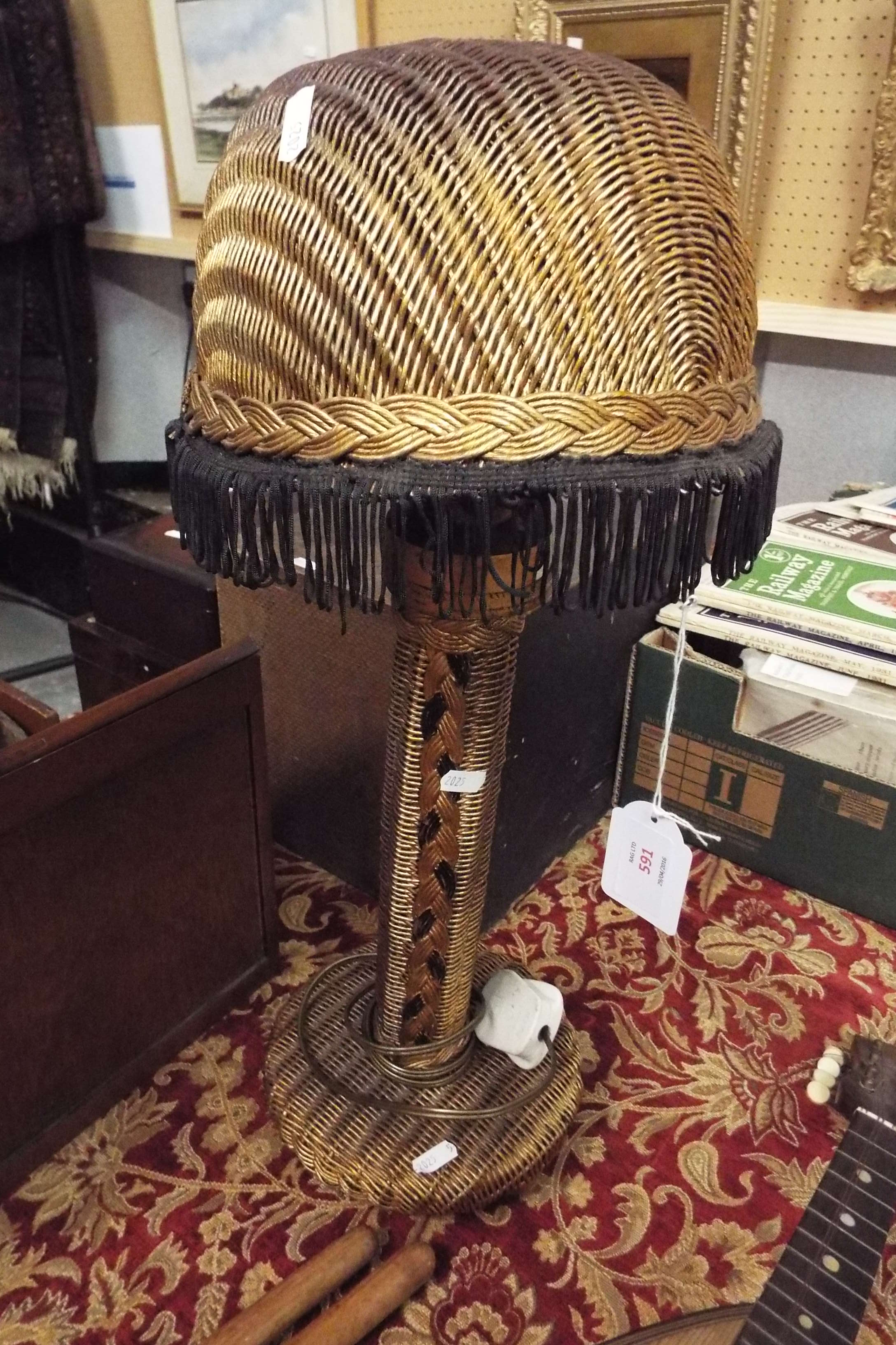 A Lloyd Loom lamp with Lloyd Loom shade in gold colourway