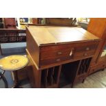 An oak pedestal estates desk having hinged lid writing slope above four short drawers,