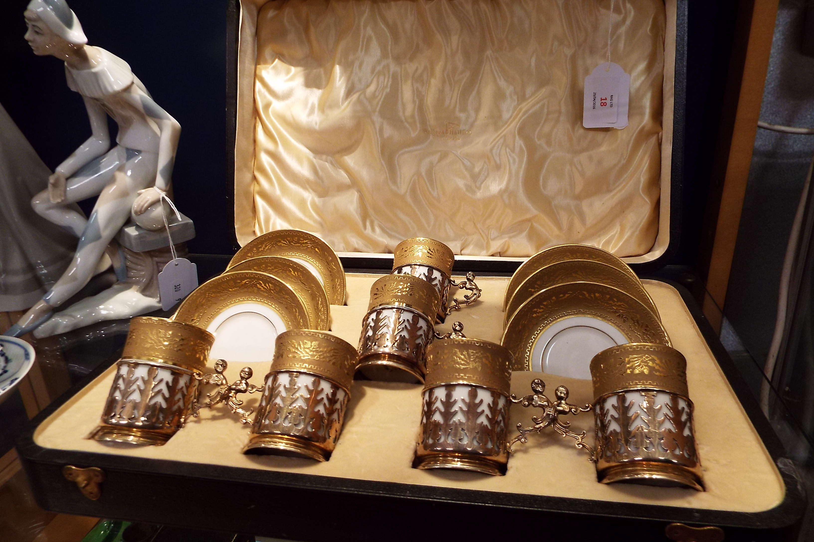 A cased set of Limoges coffee cans and saucers heavily decorated with floral and Greek key gilt