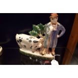 A Rye Pottery figurine 'Farmer with Sussex Pig'