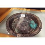 A late 19thC Indian brass bowl engraved with floral scrolls and script to central panel