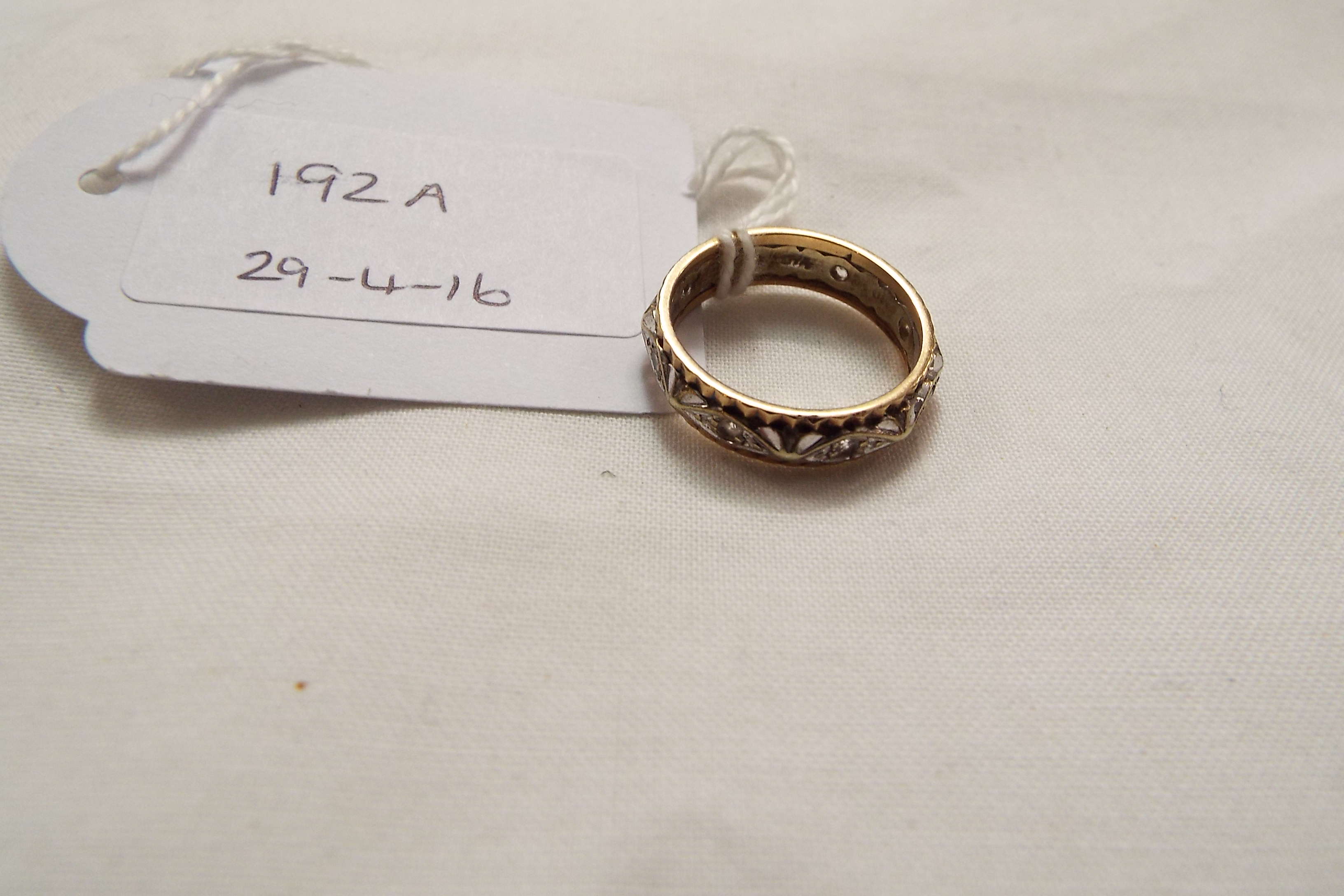 A two tone gold eternity ring set with clear stones,