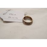 A two tone gold eternity ring set with clear stones,
