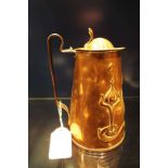 An Art Nouveau decorated embossed copper lidded hot water jug (A/F)