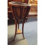 An Edwardian mahogany and satinwood lined jardiniere stand having strap-work gallery over a shell