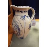 A Rye Pottery white glazed water jug with blue and white decoration of a pig,