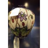 A modern Moorcroft vase of ovoid form with blue floral decoration, signed to the base,