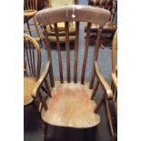 A late 19thC / early 20thC elm lathe back Windsor armchair with scrolled arms and solid seat,