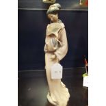 A Nao figurine of a geisha girl with a fan