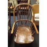 A Victorian elm double comb back Windsor armchair, the hoop arms over a solid seat,