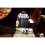 An early Delft blue and white porcelain canister tea-caddy having pictorial panels,