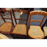 Three Edwardian mahogany and elm side chairs one with ivory studs to back rails and each with cane