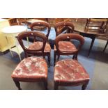 A set of four mid-19thC mahogany balloon back dining chairs with original red leather upholstered