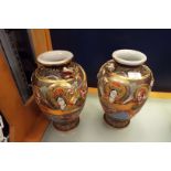 A pair of Satsuma style vases decorated with dragons and deities
