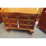 A walnut 1/4 veneered cocktail cabinet with shaped tray top with pull down flap enclosing inner