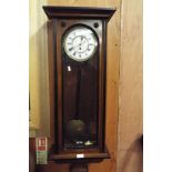 An early 20thC walnut and ebonised cased wall clock,