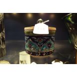 A mid 20thC Palestine Iznik ceramic lidded tobacco jar decorated with geometric band between floral