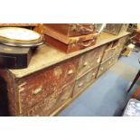 A late 19thC stained pine shop counter chest of eight large deep drawers originally from a hardware